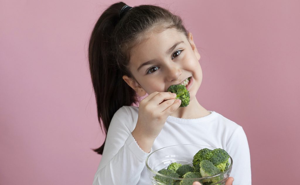 فتاة صغيرة تأكل البروكولي