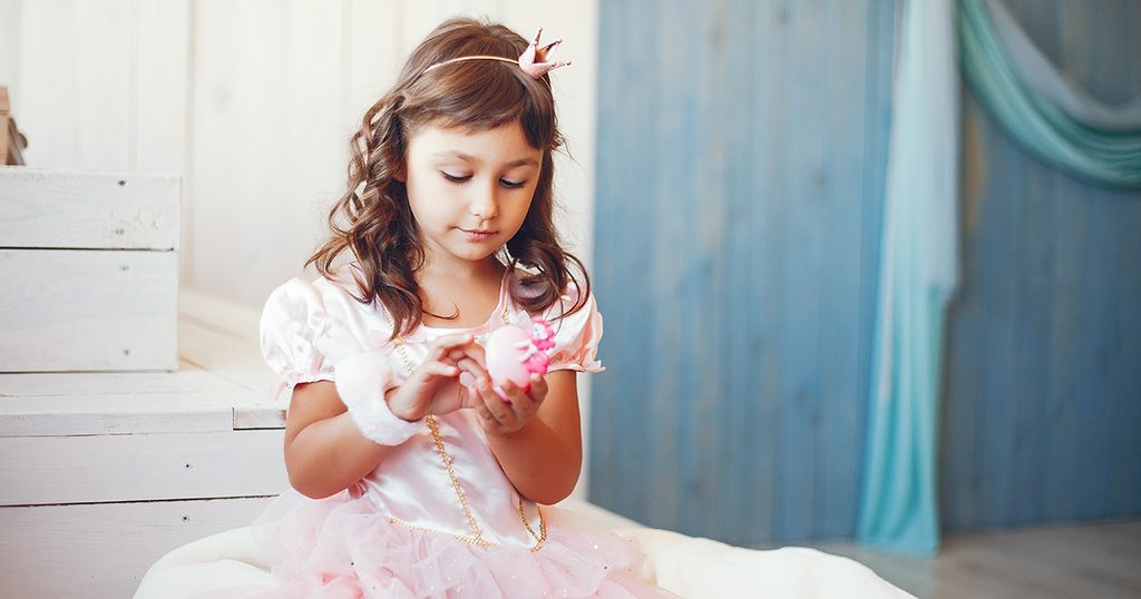 طفلة صغيرة كالأميرات تلعب بدميتها