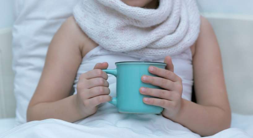 طفلة مريضة تشرب شاي ساخن