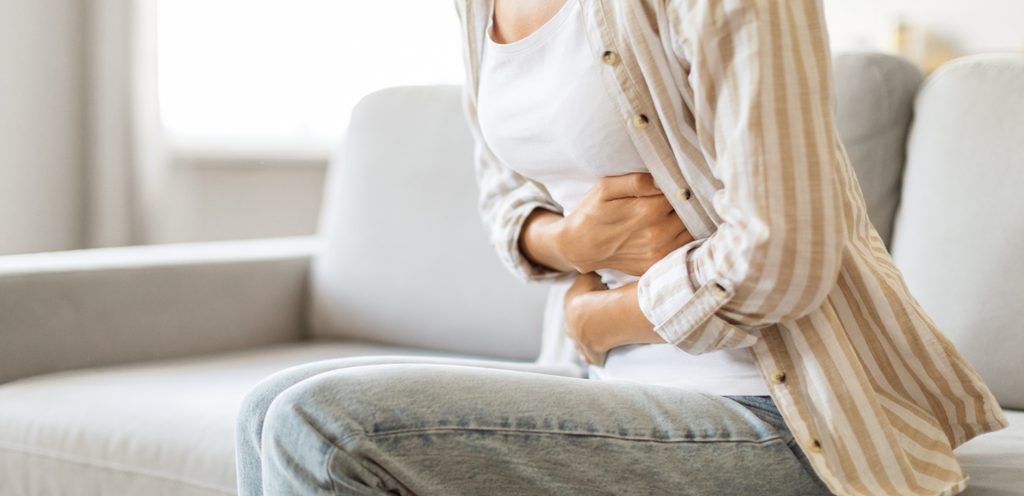 امرأة تُعاني من ألم الأمعاء