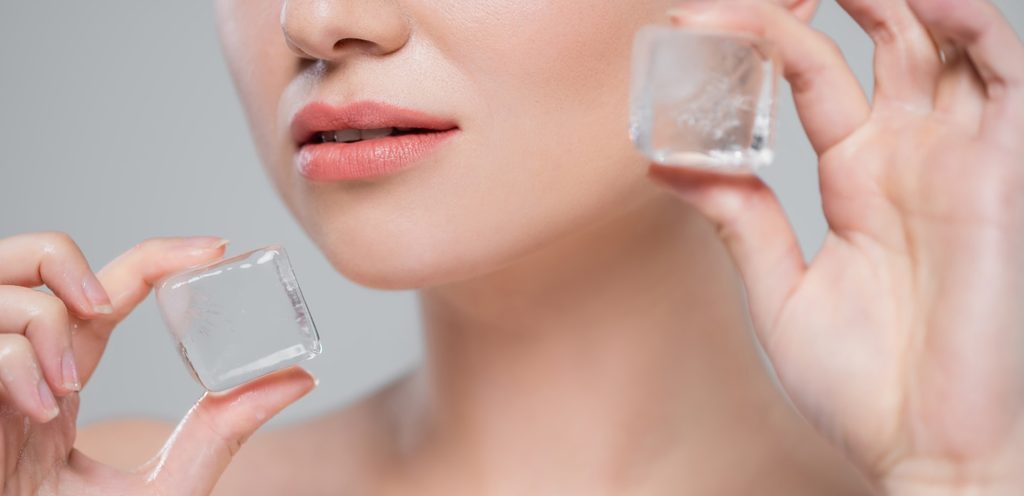 امرأة تمسك بقطعة الثلج