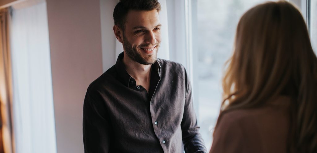 رجل ينظر مبتسمًا إلى شريكته