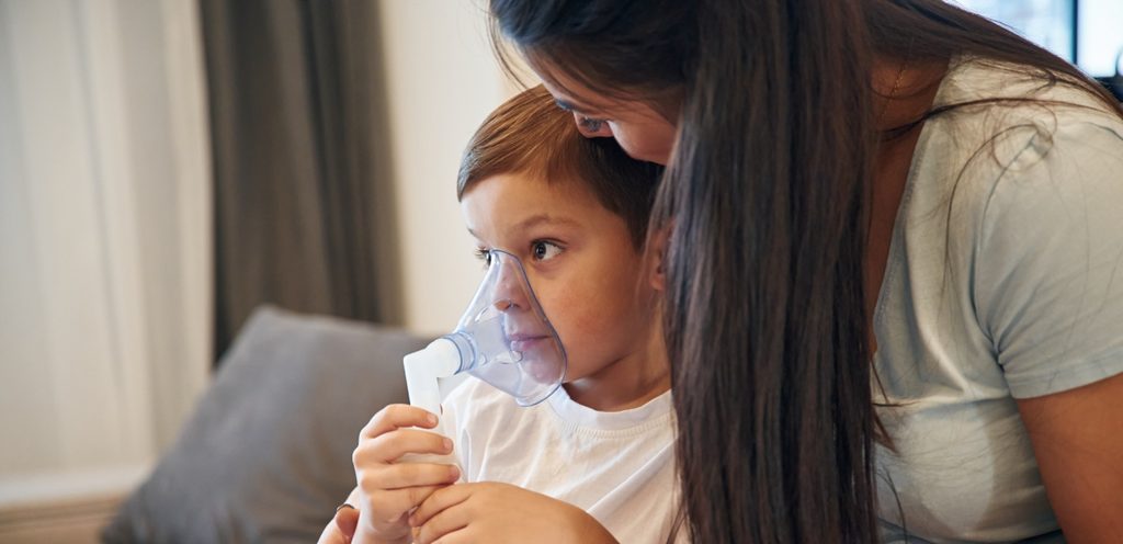 أم تضع لطفلها قناع الأكسجين