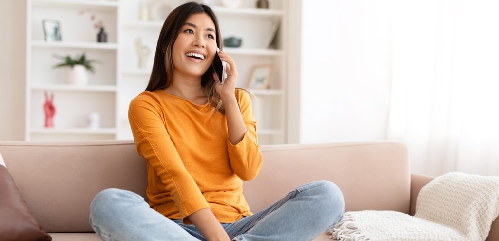 امرأة سعيدة تتكلّم على الهاتف