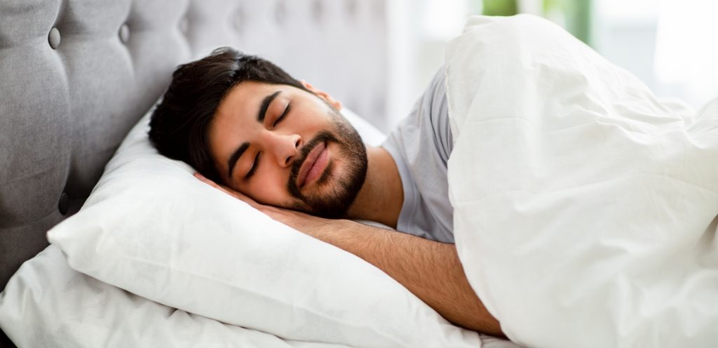 رجل سعيد نائم في السرير