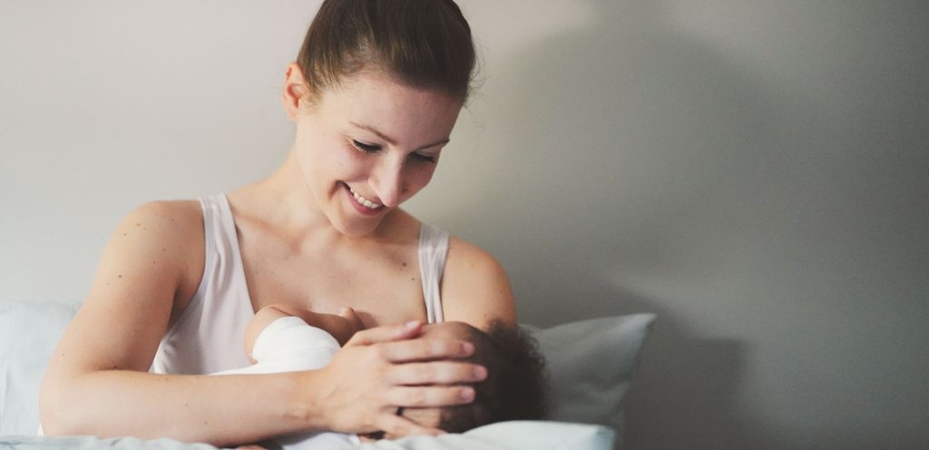 امرأة سعيدة تحمل رضيعها