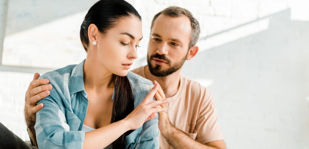 امرأة حزينة ورجل يواسيها