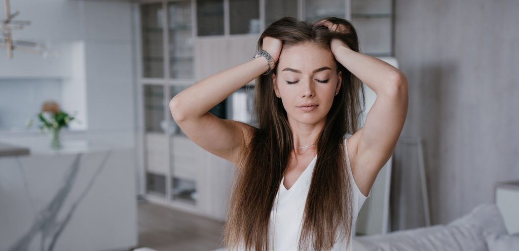 امرأة تضع يديها على رأسها