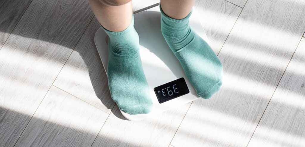 طفل يقف على الميزان