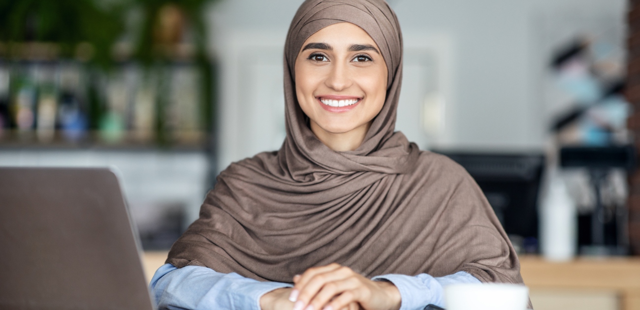 شابة تجلس أمام الحاسوب